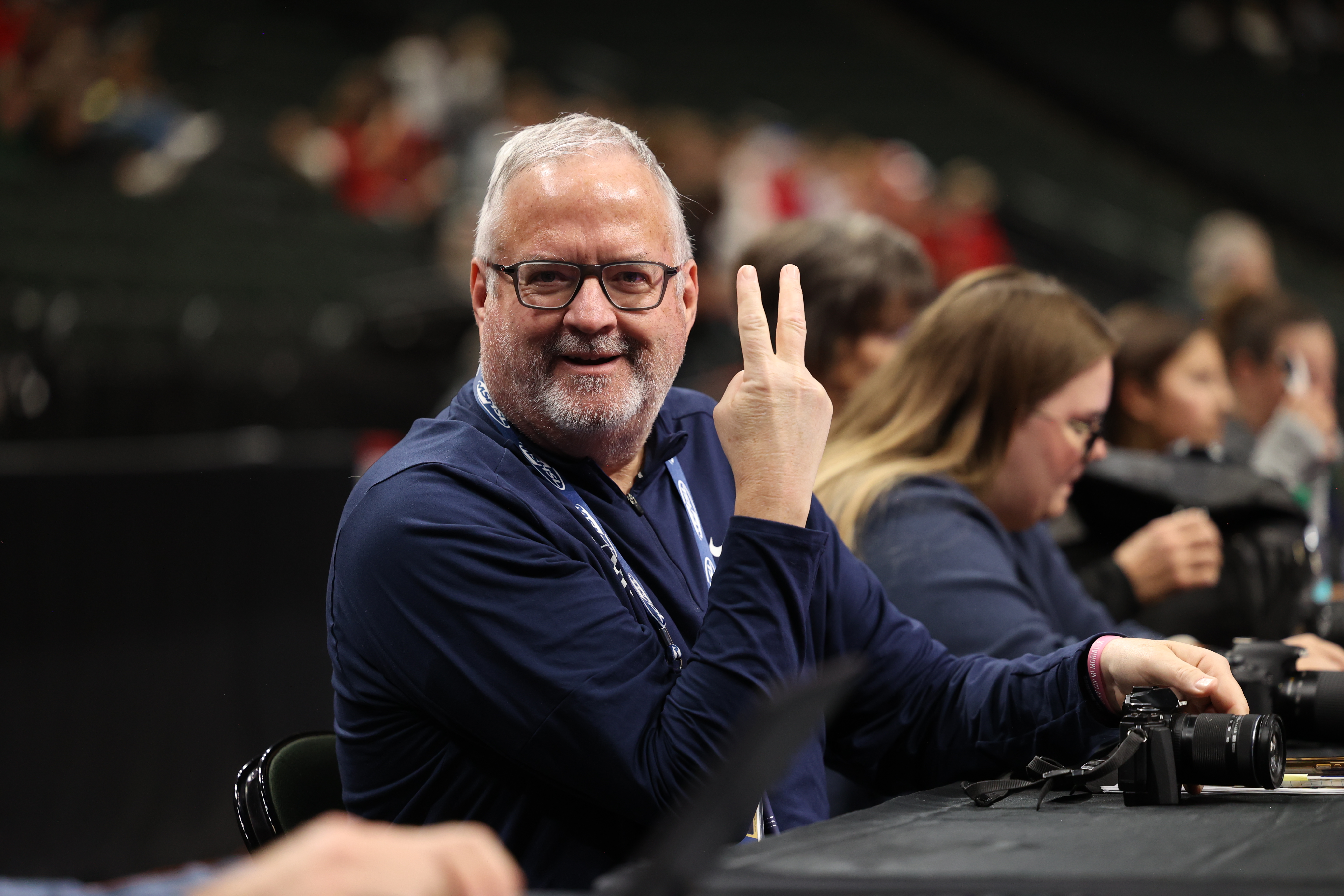 John Millea holds up two fingers on press row
