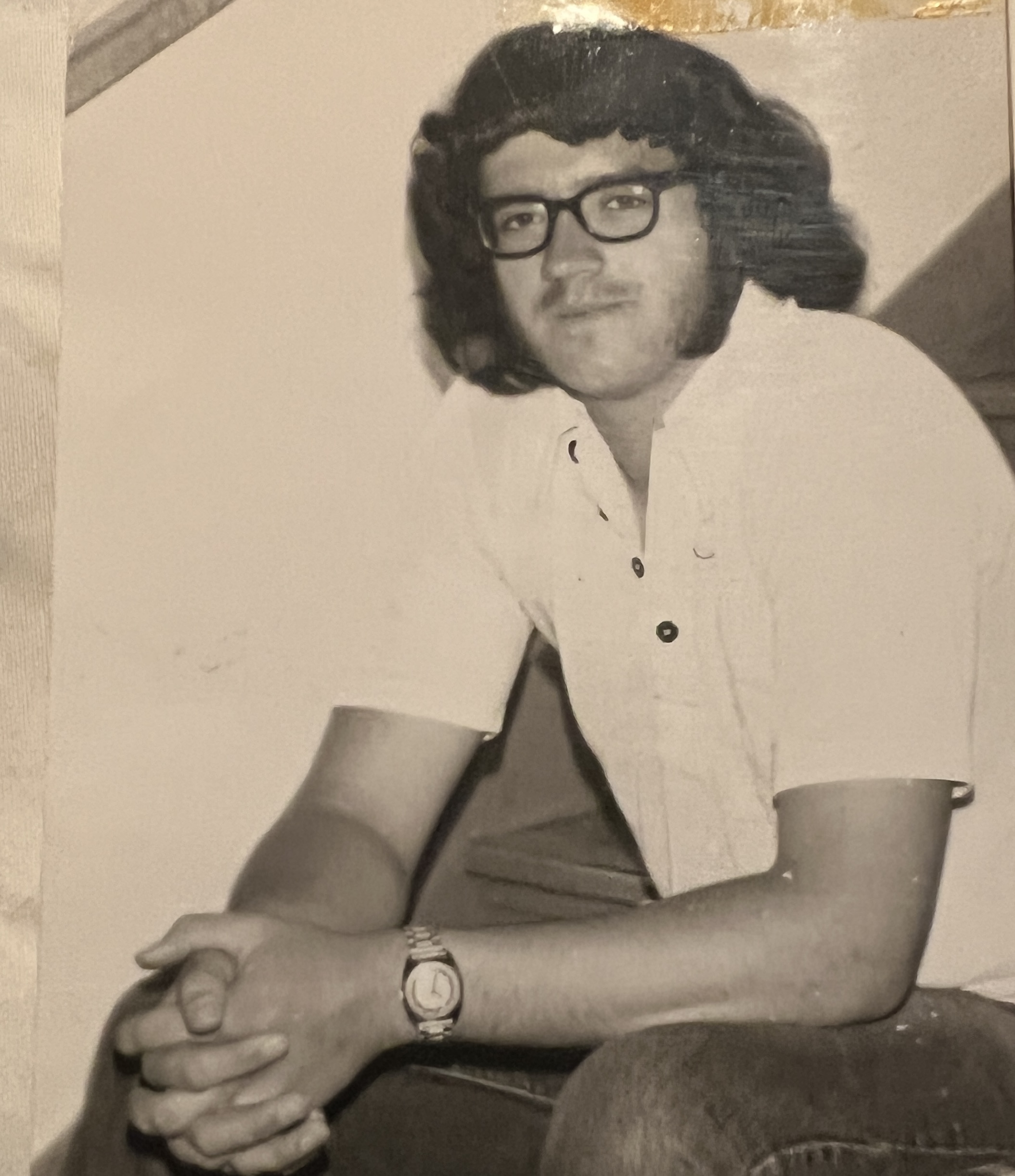 John Millea sitting on the stars as a high school student.