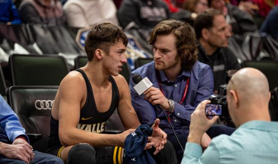 Wrestler being interviewed by media with mic