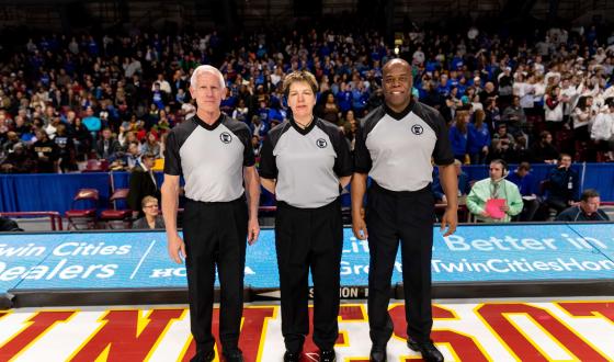 Three Basketball Officials standing on the court