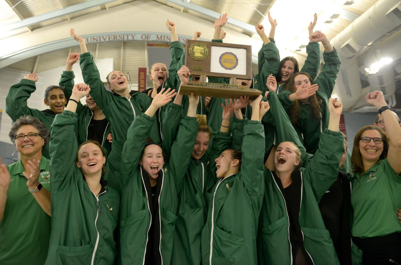 Photo of Edina accepting team trophy