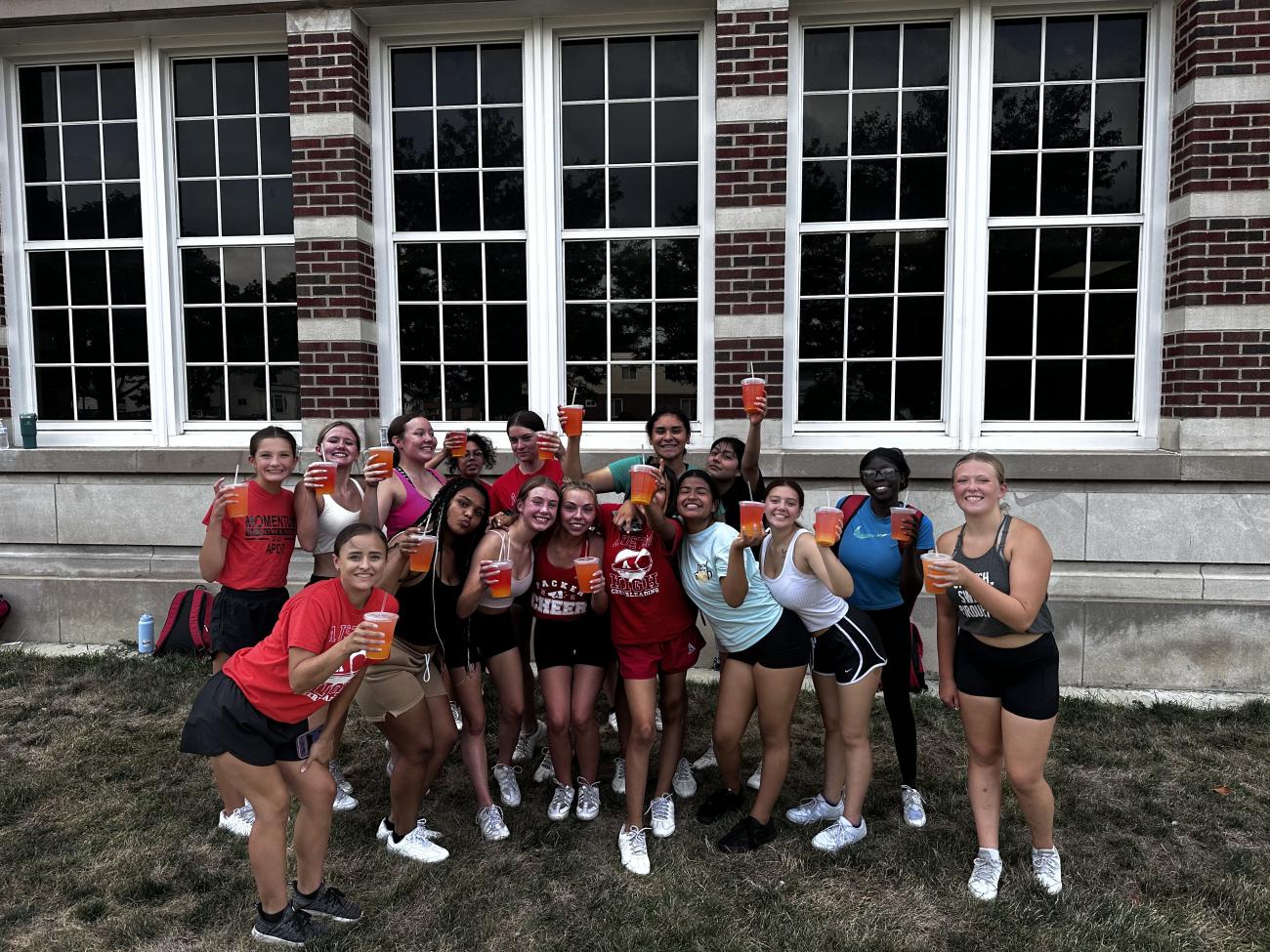 Cheerleaders enjoying my an energy drink on a hot summer practice 