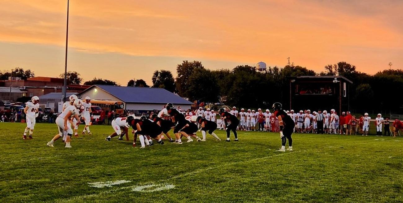 Football line of scrimmage with sunset
