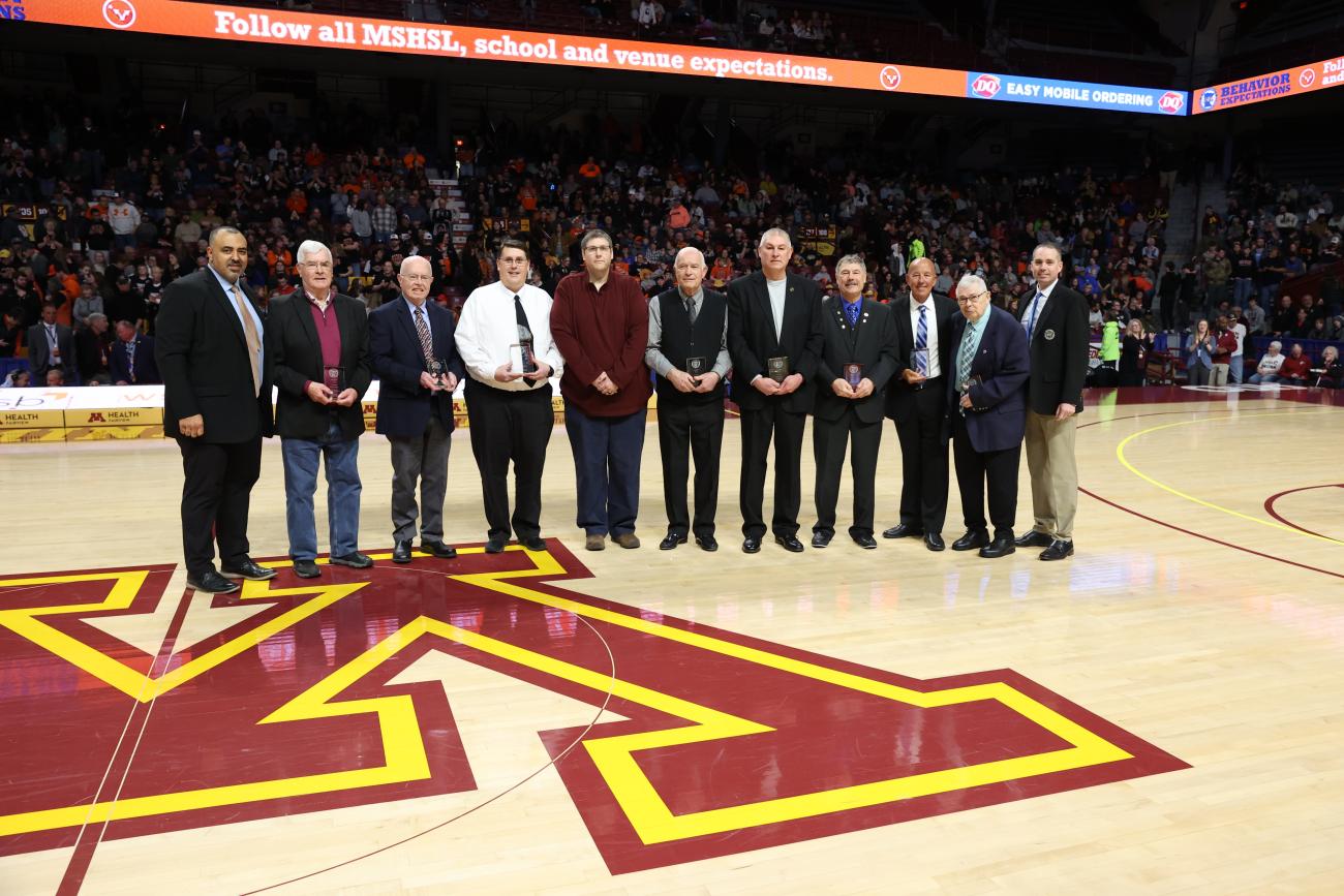 The 2025 Officials Distinguished Service Award winners are honored at Williams Arena.