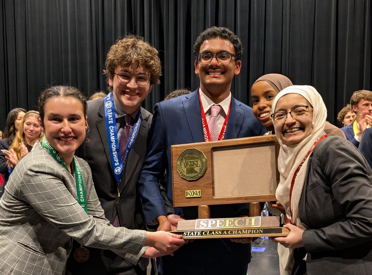 Mounds Park Academy Speech captains hold their Class A state championship trophy.